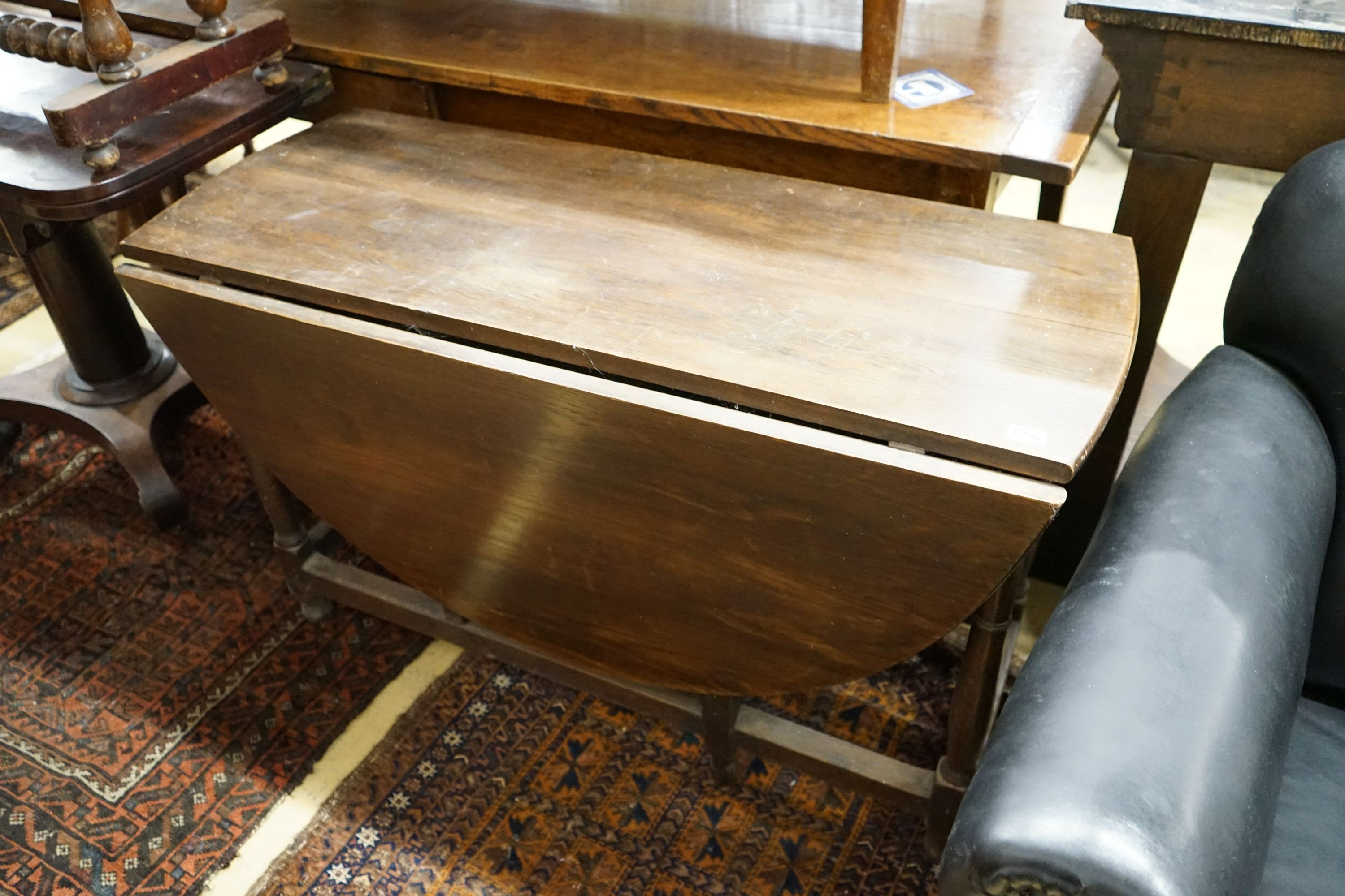 An 18th century style oak gateleg dining table, width 112cm, 140cm extended, height 68cm